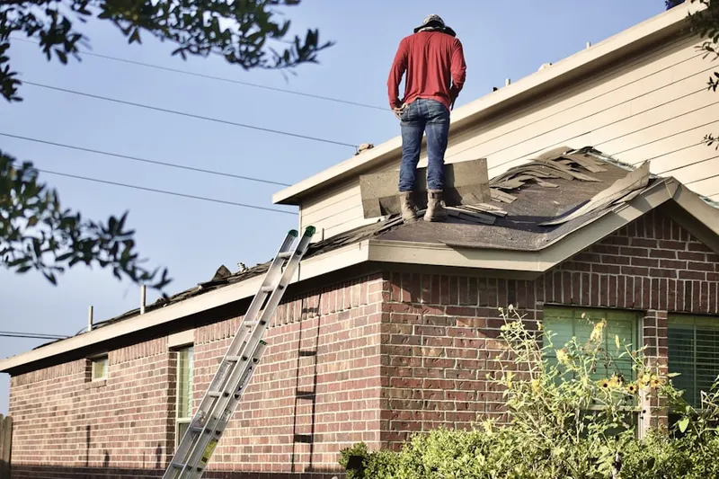 Professional roofer working on a residential roof in Pleasant Valley Homes